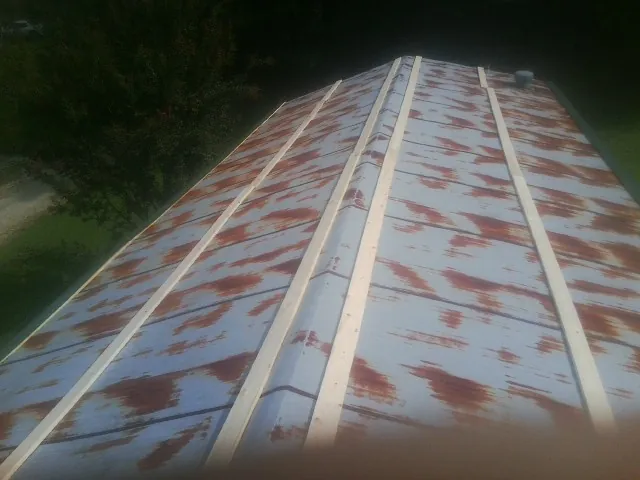 Rusted metal roof panels with new wood purlins before replacement — Storm Damage Roof Repair in Mullica Hill by Roofing Brothers